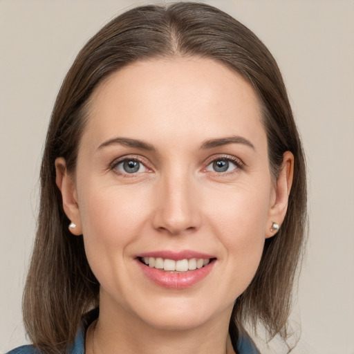 Joyful white young-adult female with medium  brown hair and grey eyes