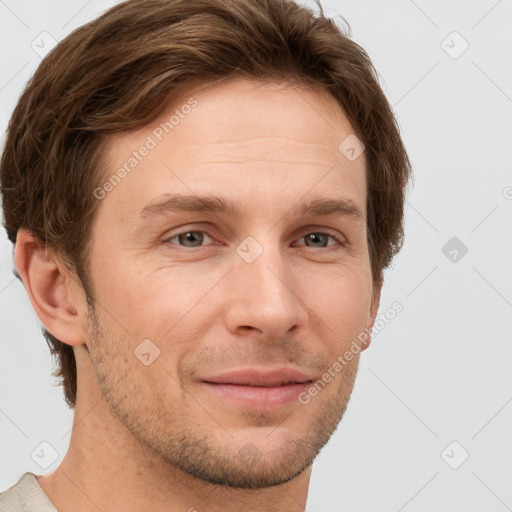 Joyful white adult male with short  brown hair and grey eyes