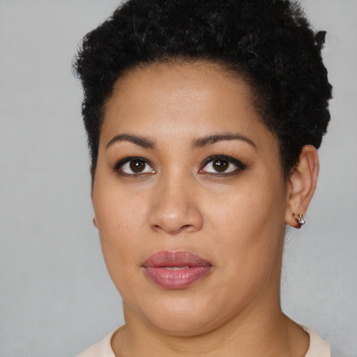 Joyful latino young-adult female with short  brown hair and brown eyes