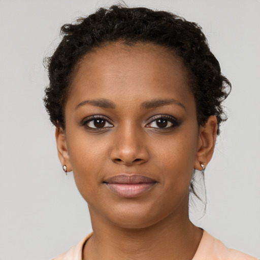 Joyful black young-adult female with short  brown hair and brown eyes