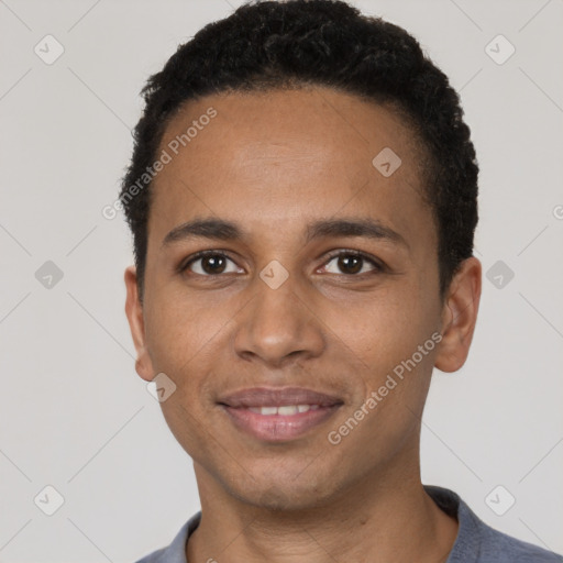 Joyful black young-adult male with short  black hair and brown eyes