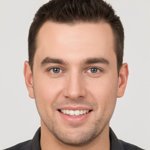 Joyful white young-adult male with short  brown hair and brown eyes