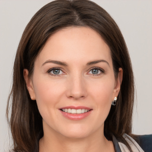 Joyful white young-adult female with medium  brown hair and grey eyes