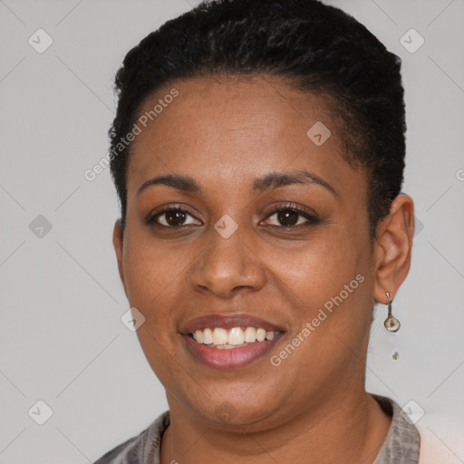 Joyful black young-adult female with short  brown hair and brown eyes