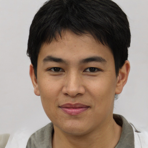 Joyful asian young-adult male with short  brown hair and brown eyes