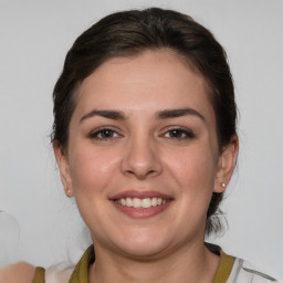 Joyful white young-adult female with medium  brown hair and grey eyes