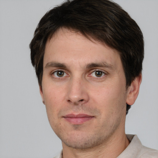 Joyful white adult male with short  brown hair and brown eyes