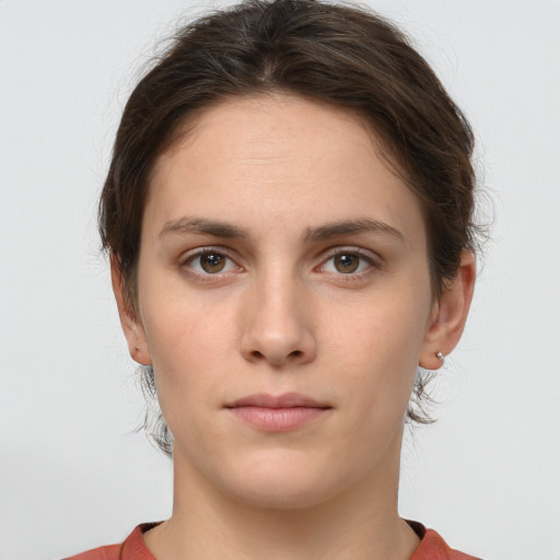 Neutral white young-adult female with short  brown hair and brown eyes