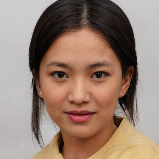 Joyful asian young-adult female with medium  brown hair and brown eyes