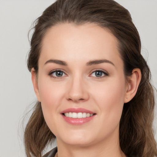 Joyful white young-adult female with long  brown hair and grey eyes