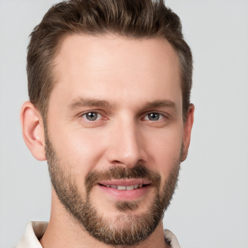 Joyful white young-adult male with short  brown hair and brown eyes