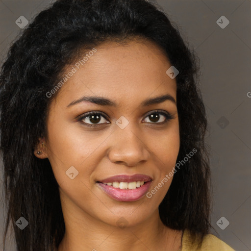 Joyful black young-adult female with long  brown hair and brown eyes