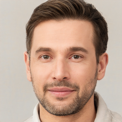 Joyful white young-adult male with short  brown hair and brown eyes