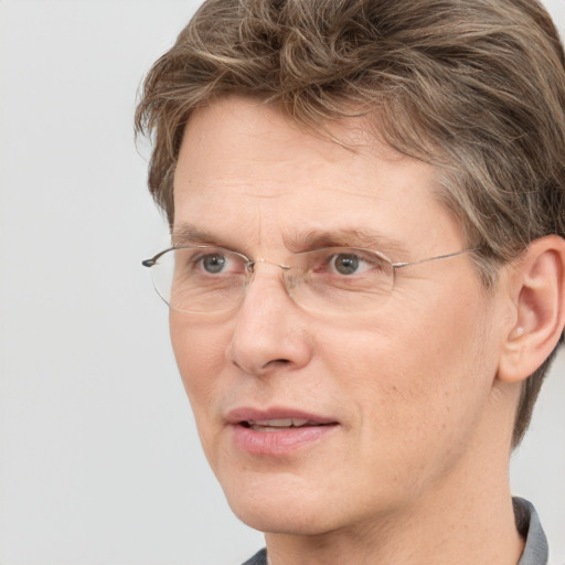 Joyful white adult male with short  brown hair and grey eyes