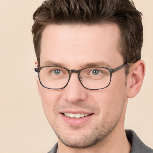 Joyful white adult male with short  brown hair and grey eyes