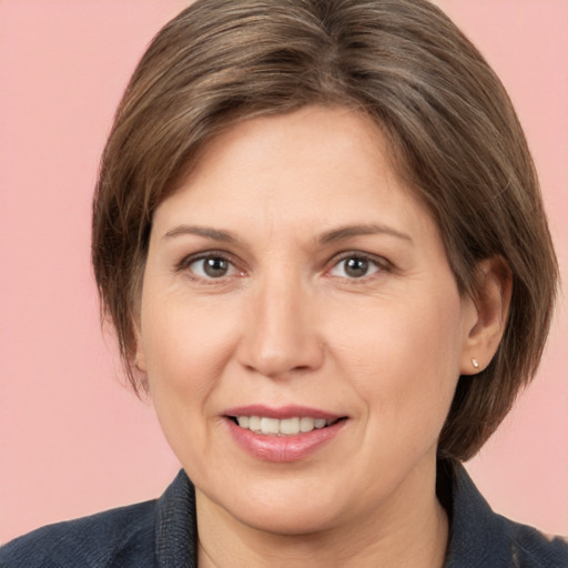 Joyful white adult female with medium  brown hair and brown eyes