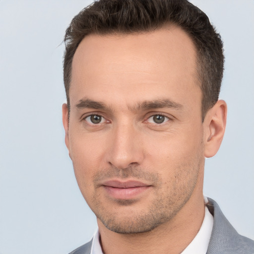 Joyful white young-adult male with short  brown hair and brown eyes