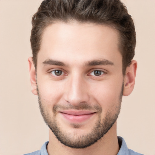 Joyful white young-adult male with short  brown hair and brown eyes