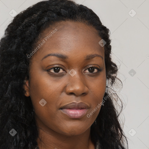 Joyful black young-adult female with long  brown hair and brown eyes