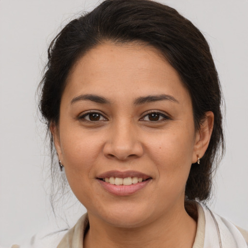 Joyful latino young-adult female with medium  brown hair and brown eyes