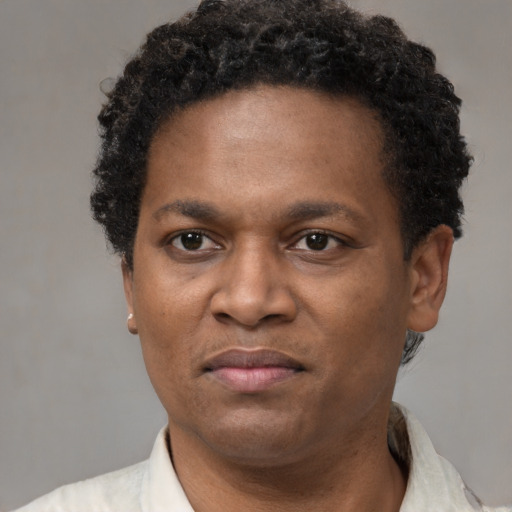 Joyful black adult male with short  brown hair and brown eyes