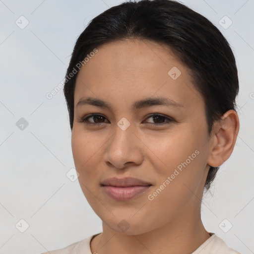 Joyful latino young-adult female with short  brown hair and brown eyes