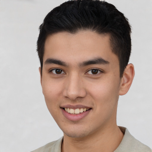 Joyful asian young-adult male with short  brown hair and brown eyes