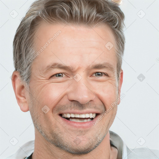 Joyful white adult male with short  brown hair and grey eyes