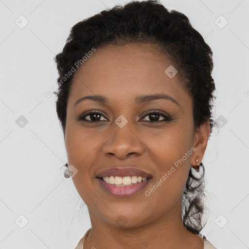 Joyful black young-adult female with short  black hair and brown eyes