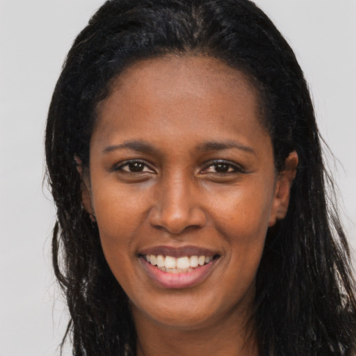 Joyful latino young-adult female with long  brown hair and brown eyes