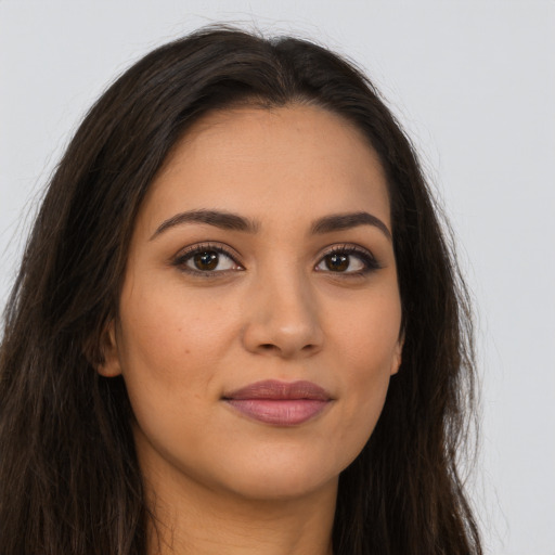 Joyful latino young-adult female with long  brown hair and brown eyes