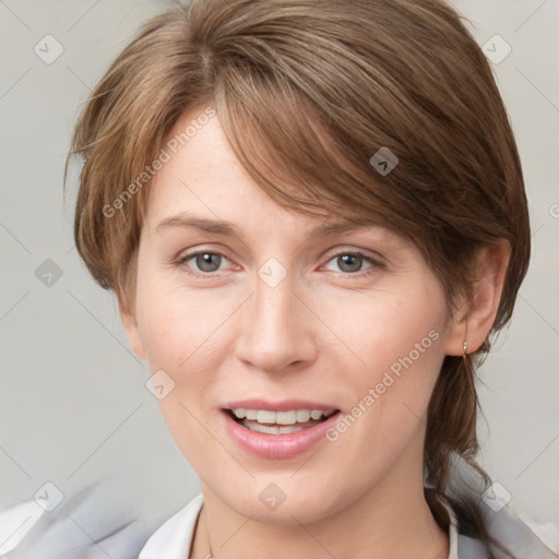 Joyful white young-adult female with medium  brown hair and blue eyes