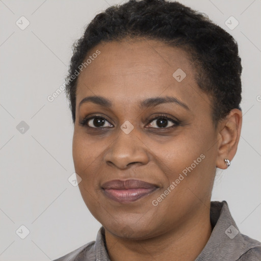 Joyful black young-adult female with short  black hair and brown eyes