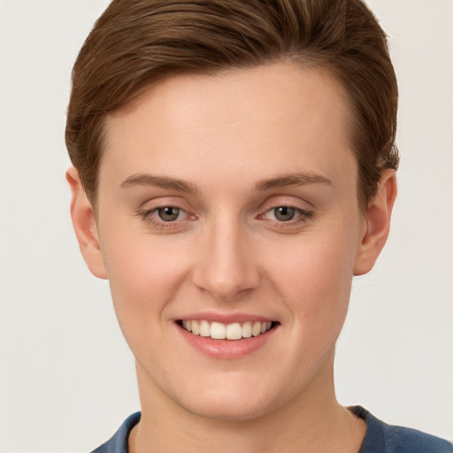 Joyful white young-adult female with short  brown hair and grey eyes