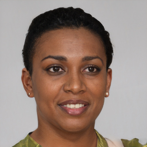 Joyful black young-adult female with short  brown hair and brown eyes