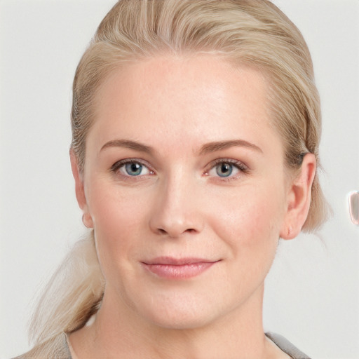 Joyful white young-adult female with long  brown hair and blue eyes