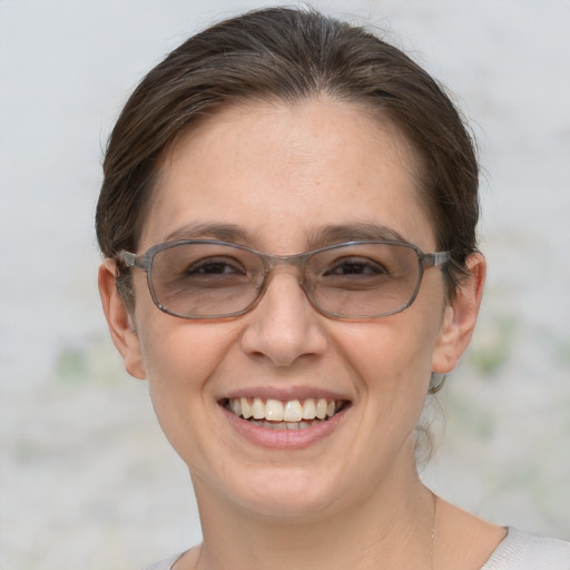 Joyful white adult female with medium  brown hair and brown eyes