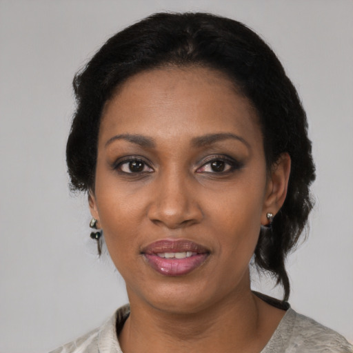 Joyful black adult female with medium  black hair and brown eyes