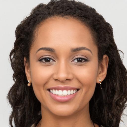 Joyful latino young-adult female with long  brown hair and brown eyes