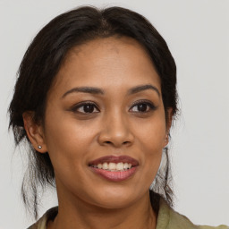 Joyful latino young-adult female with long  brown hair and brown eyes