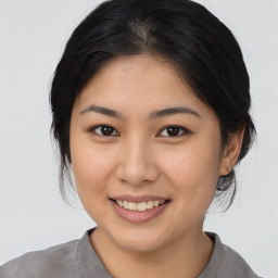 Joyful asian young-adult female with medium  brown hair and brown eyes