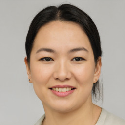 Joyful asian young-adult female with medium  brown hair and brown eyes