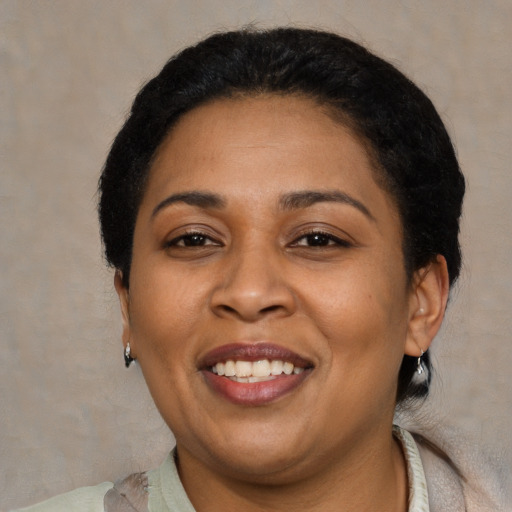 Joyful latino adult female with short  brown hair and brown eyes