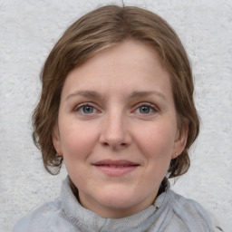 Joyful white young-adult female with medium  brown hair and blue eyes