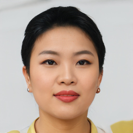 Joyful asian young-adult female with short  brown hair and brown eyes