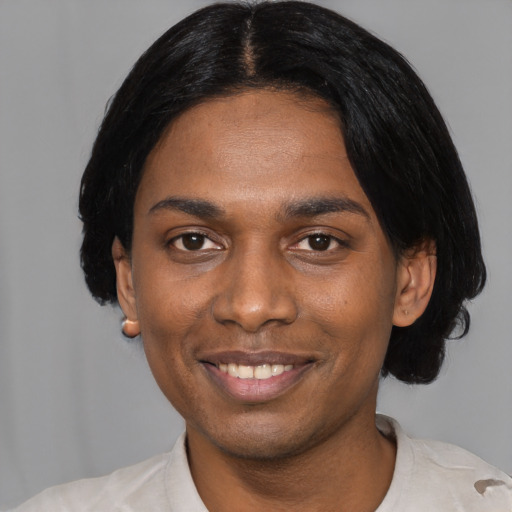 Joyful black young-adult male with short  black hair and brown eyes