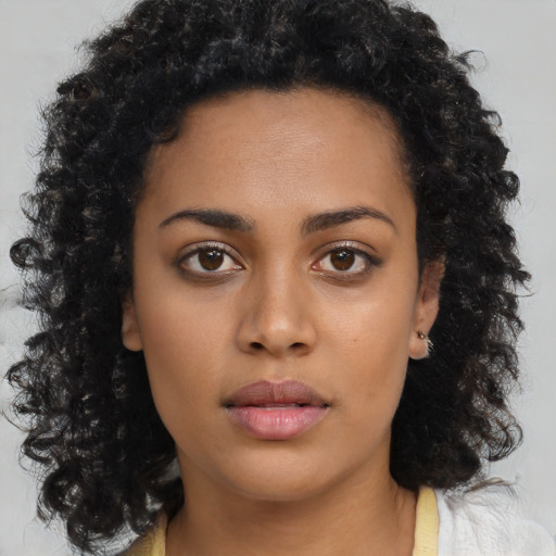 Neutral black young-adult female with long  brown hair and brown eyes