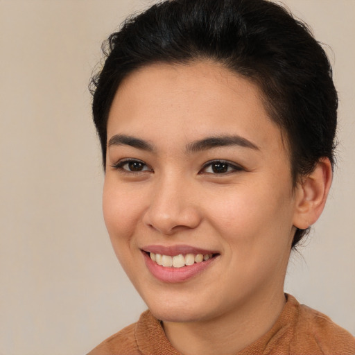 Joyful latino young-adult female with short  brown hair and brown eyes