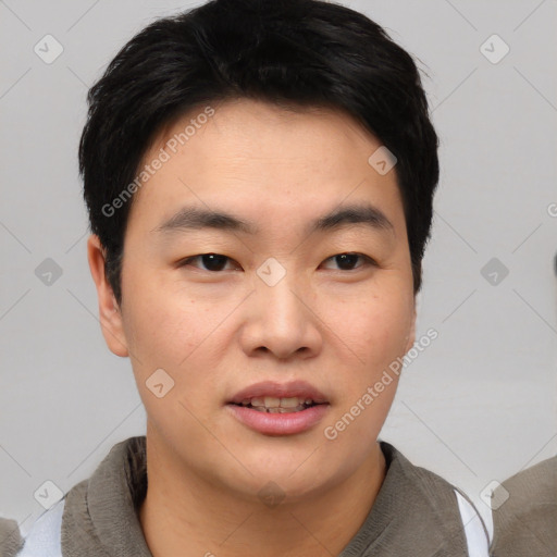 Joyful asian young-adult male with short  black hair and brown eyes