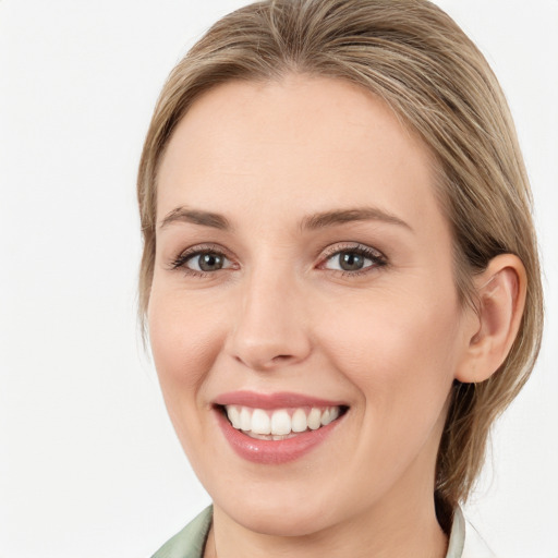 Joyful white young-adult female with medium  brown hair and blue eyes